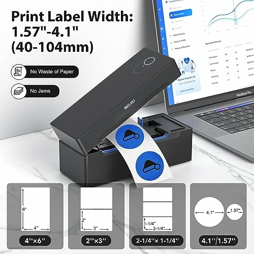 Label printer with sample labels and laptop displaying charts.