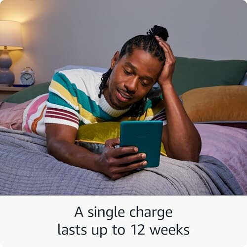 Man reading an eBook in bed, with text 'A single charge lasts up to 12 weeks'.