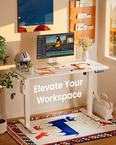 Modern desk setup with a monitor, helmet, and decor.